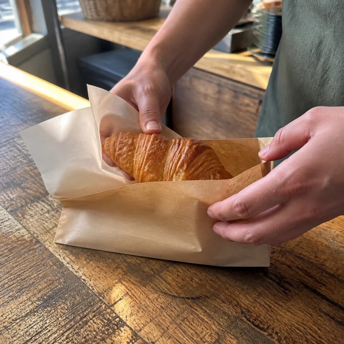 AI-generated concept photograph of hands packaging a café takeaway order